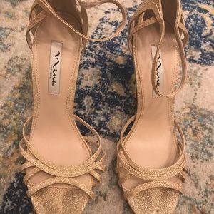 Gold sandals. Back zipper.